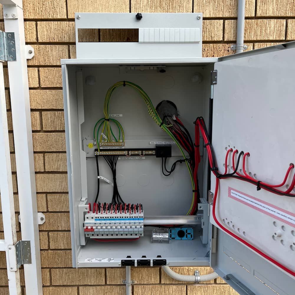 A White Box With a Bunch of Wires Inside of It — Central Electrical Group in Gracemere, QLD