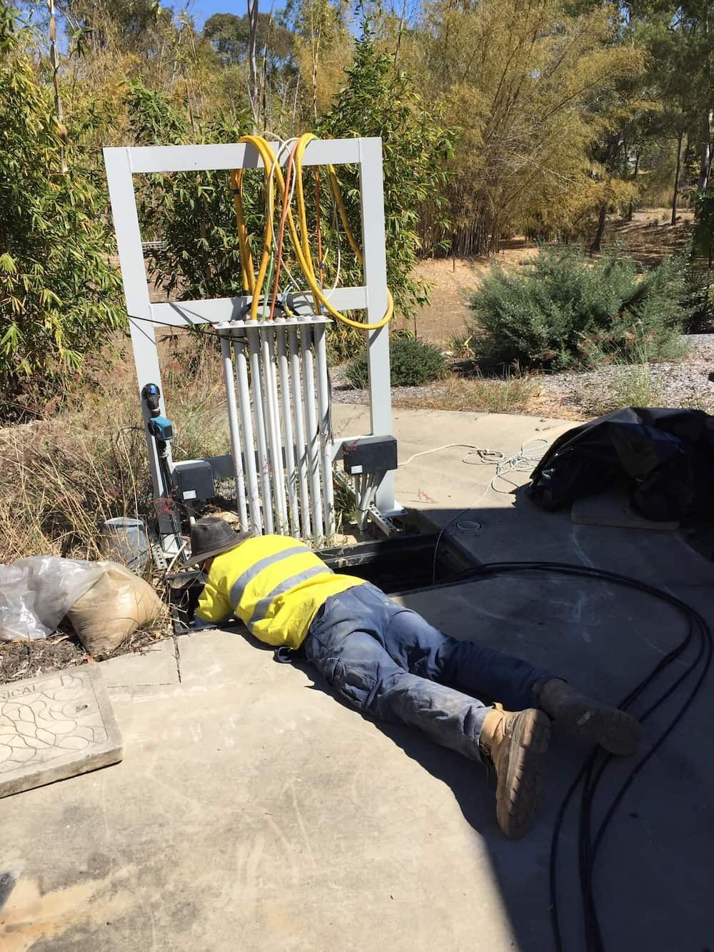 A Man is Checking the Electrical Wire on the Ground — Central Electrical Group in Gracemere, QLD