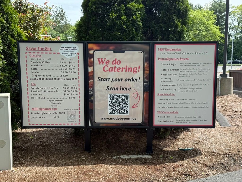 Menu board with food items, QR code for catering orders.