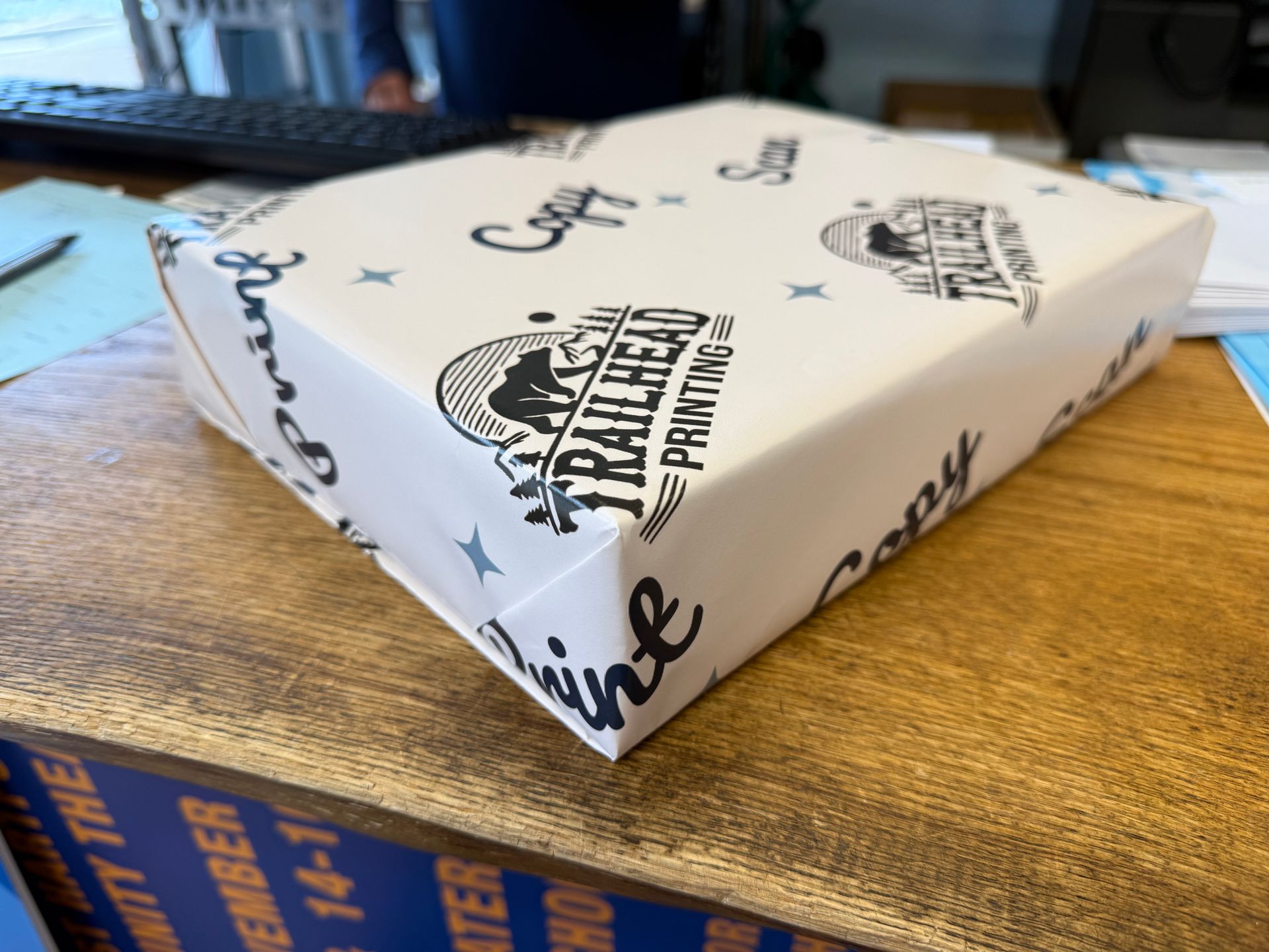 Wrapped box on a wooden counter, printed with a logo and 