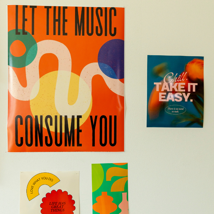 Posters on a white wall: