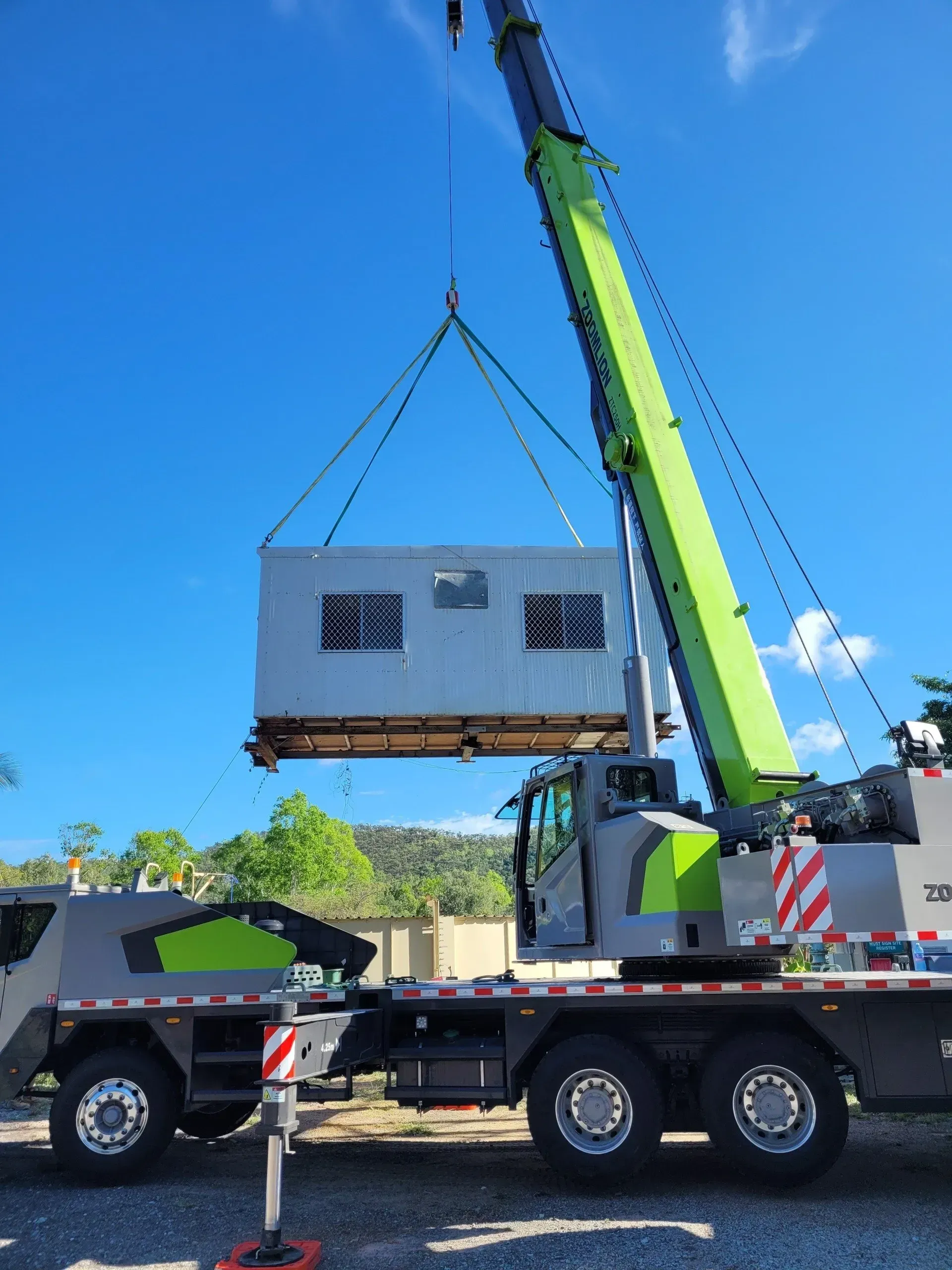 Crane Lifting a Large, Light-colored Building Module — Presto's Cranes & Rigging NQ in Garbutt, QLD
