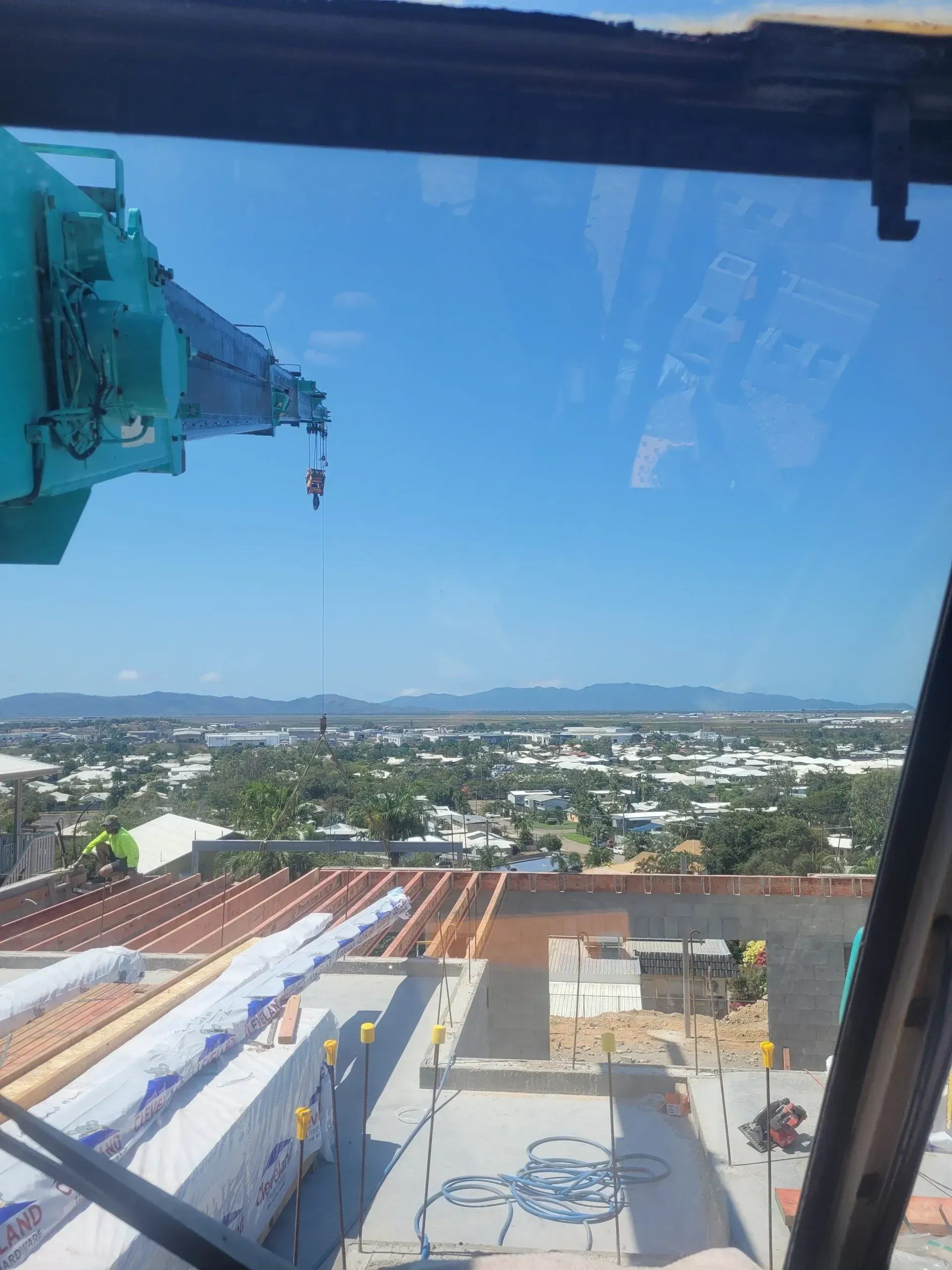 Crane Over a Construction Site With a Cityscape in the Background — Presto's Cranes & Rigging NQ in Garbutt, QLD
