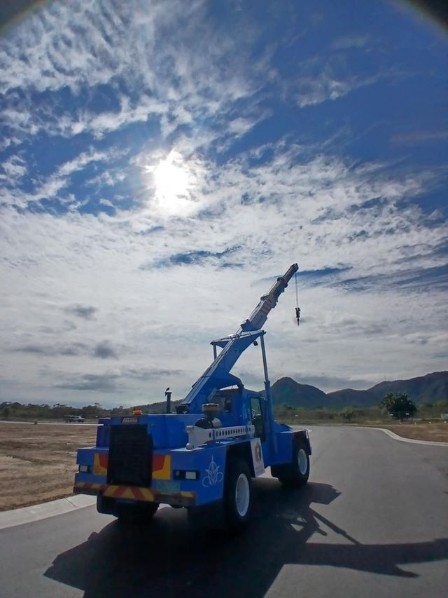 Blue Crane Truck on Road  Presto's Cranes & Rigging NQ in Garbutt, QLD