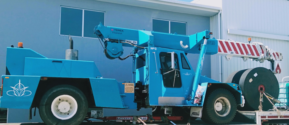 Blue Utility Truck With a Crane and Large Cable Reel — Presto's Cranes & Rigging NQ in Garbutt, QLD