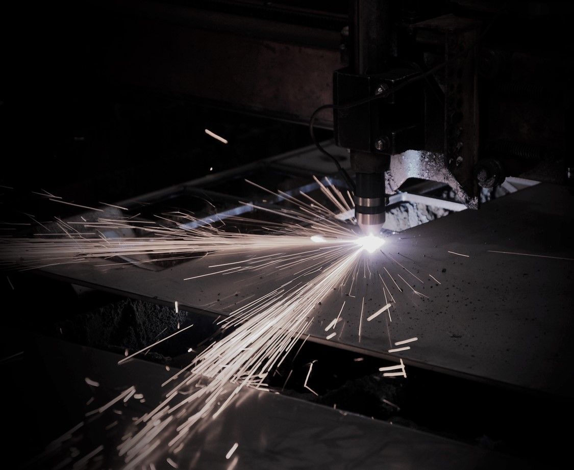 A Machine Is Cutting A Piece Of Metal With Sparks Coming Out Of It — JMG Maintenance & Fabrication In Muswellbrook NSW