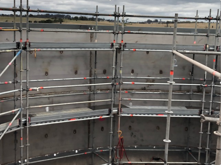 A Large Concrete Structure Is Being Built With Scaffolding Around It — JMG Maintenance & Fabrication In Muswellbrook NSW