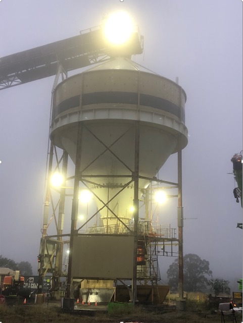 A Large Building With A Conveyor Belt Is Lit Up At Night — JMG Maintenance & Fabrication In Muswellbrook NSW