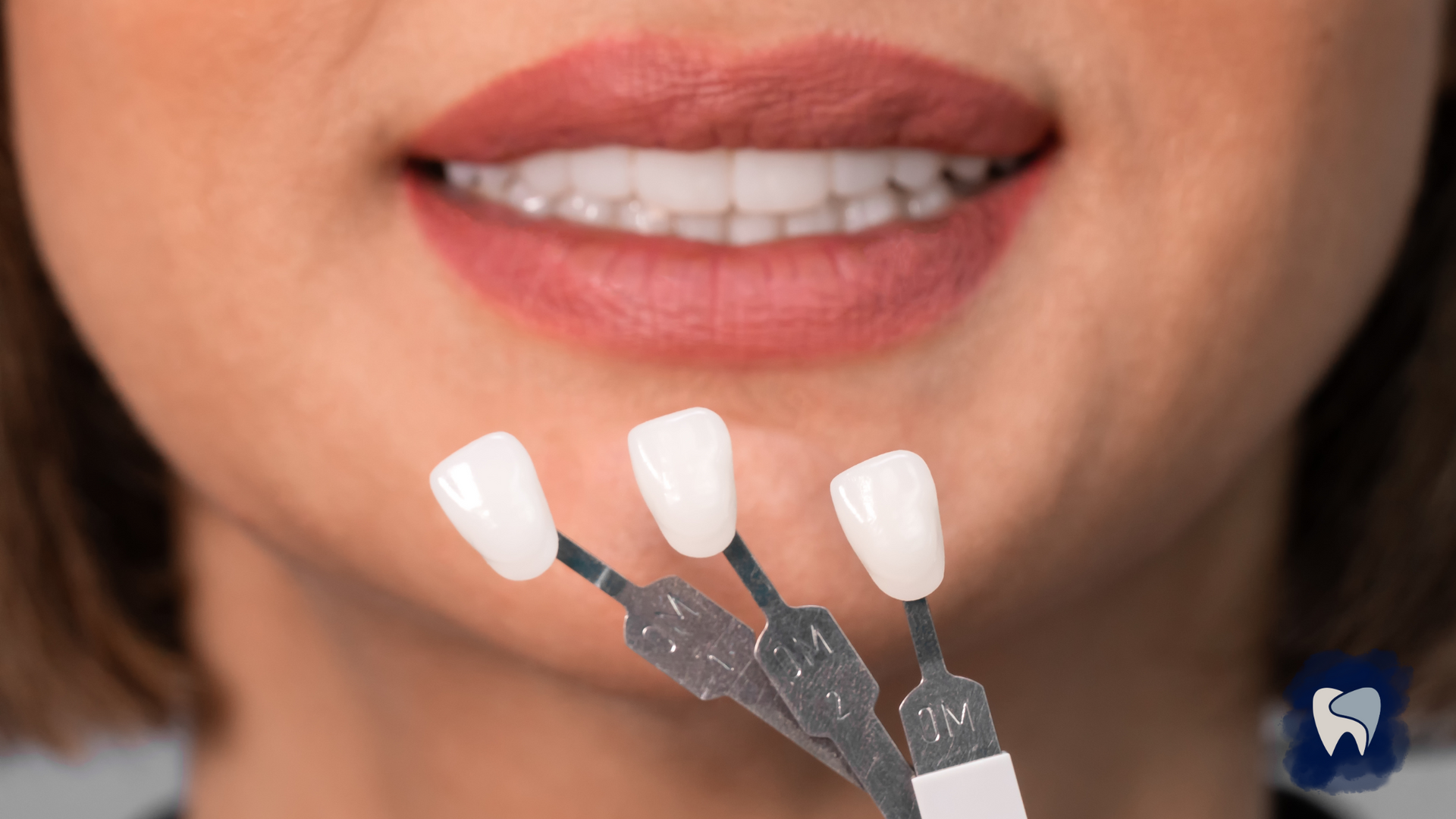 A woman is holding three tooth samples in front of her mouth.