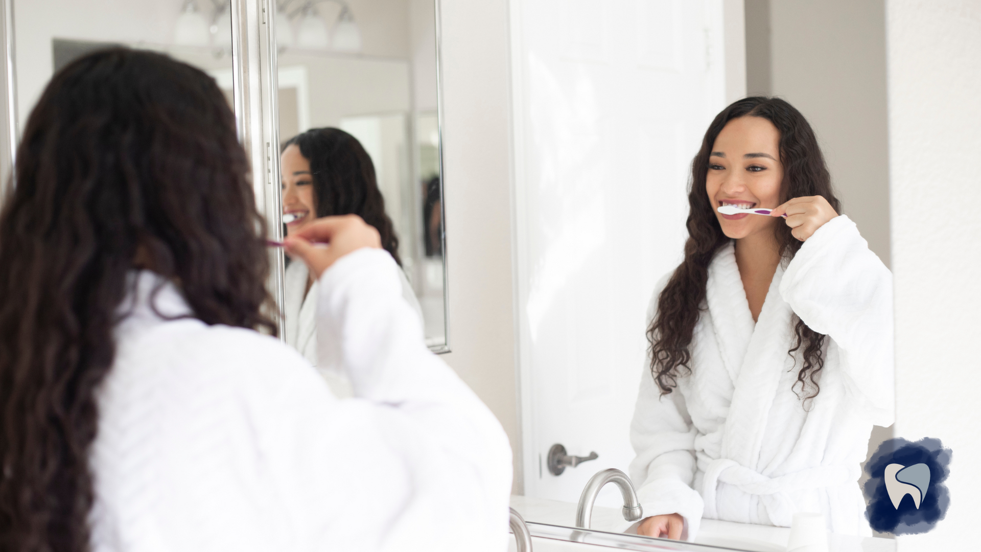 A woman is brushing her teeth in front of a mirror.