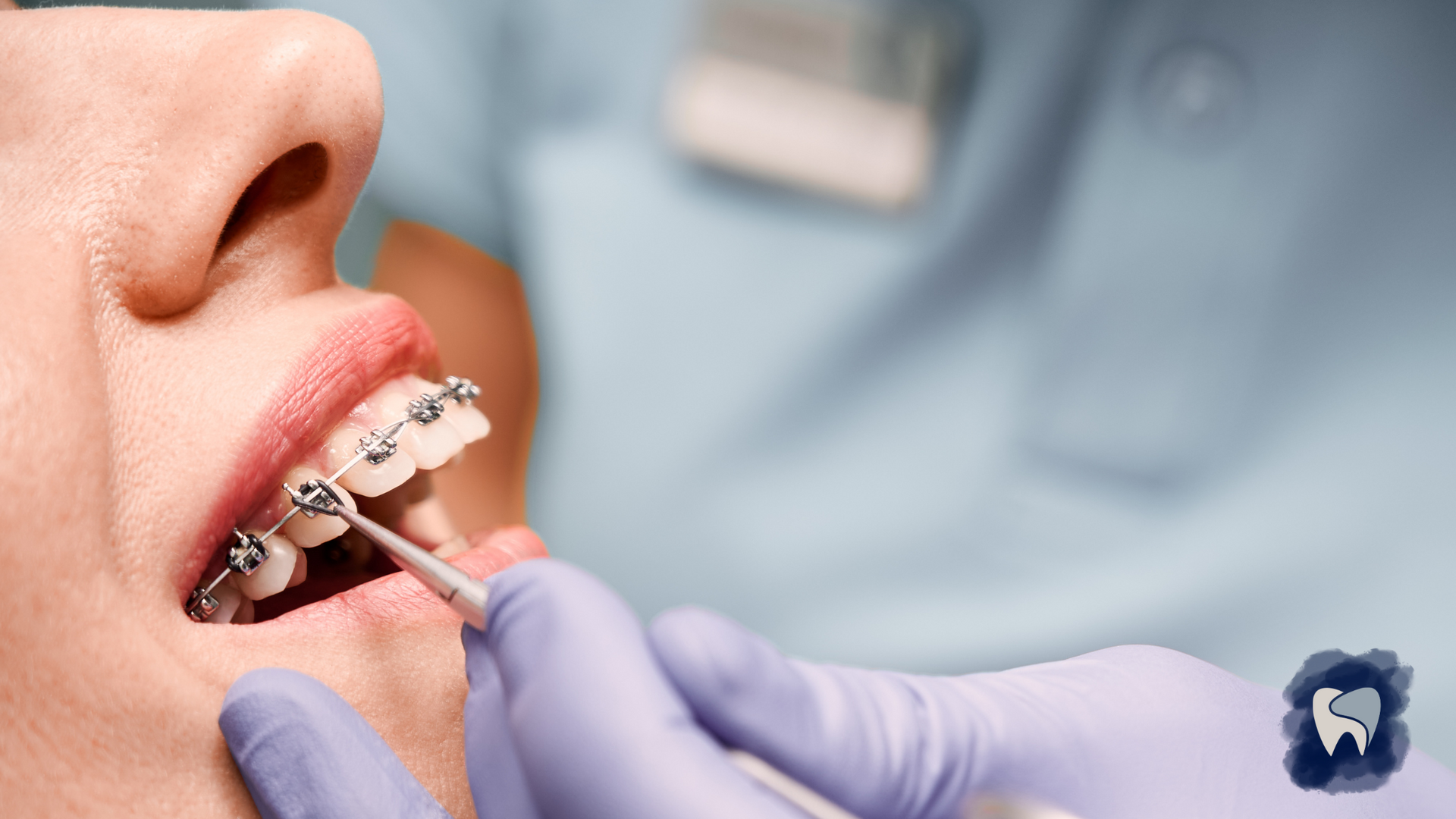 A woman is getting her teeth examined by a dentist.