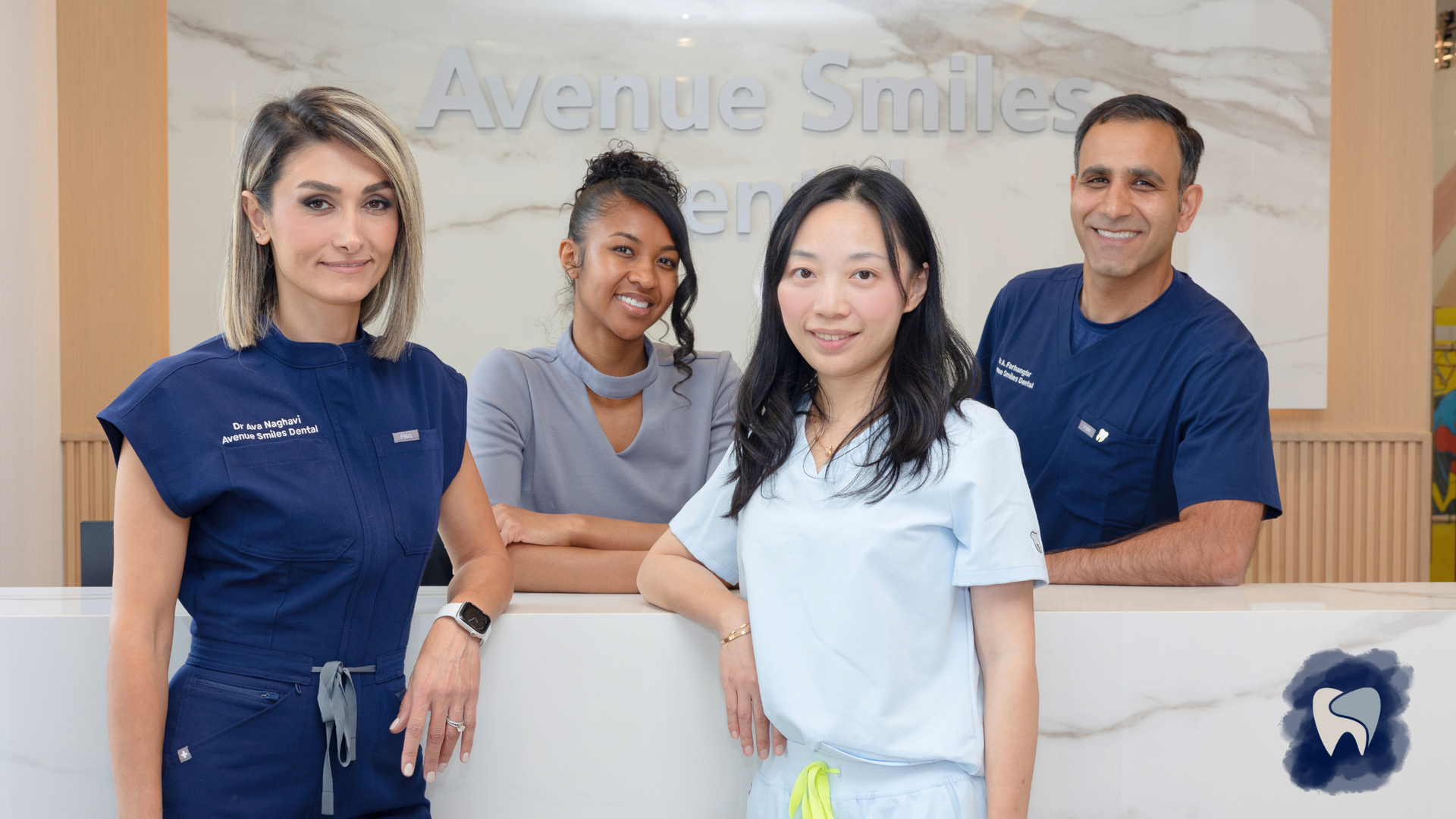 A group of dentists are posing for a picture in a dental office.