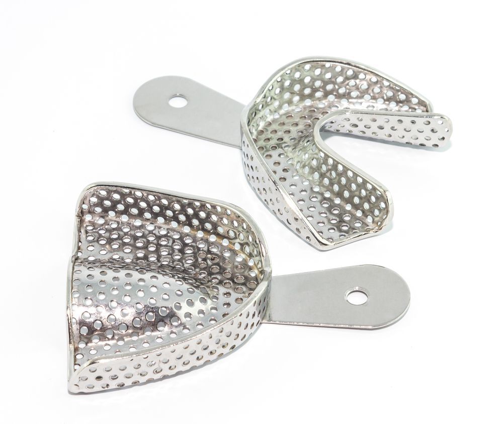 A Pair of Stainless Steel Dental Trays With Handles on a White Background — Maroochy Denture Clinic In Yandina, QLD
