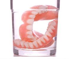 Dentures in a clear glass, immersed in a liquid — Maroochy Denture Clinic In Yandina, QLD
