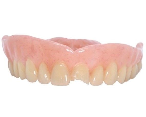 Dentures: Pink plastic base with off-white teeth; one central tooth appears broken — Maroochy Denture Clinic In Yandina, QLD