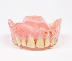 Upper dentures, pink plastic base with yellowed artificial teeth — Maroochy Denture Clinic In Yandina, QLD