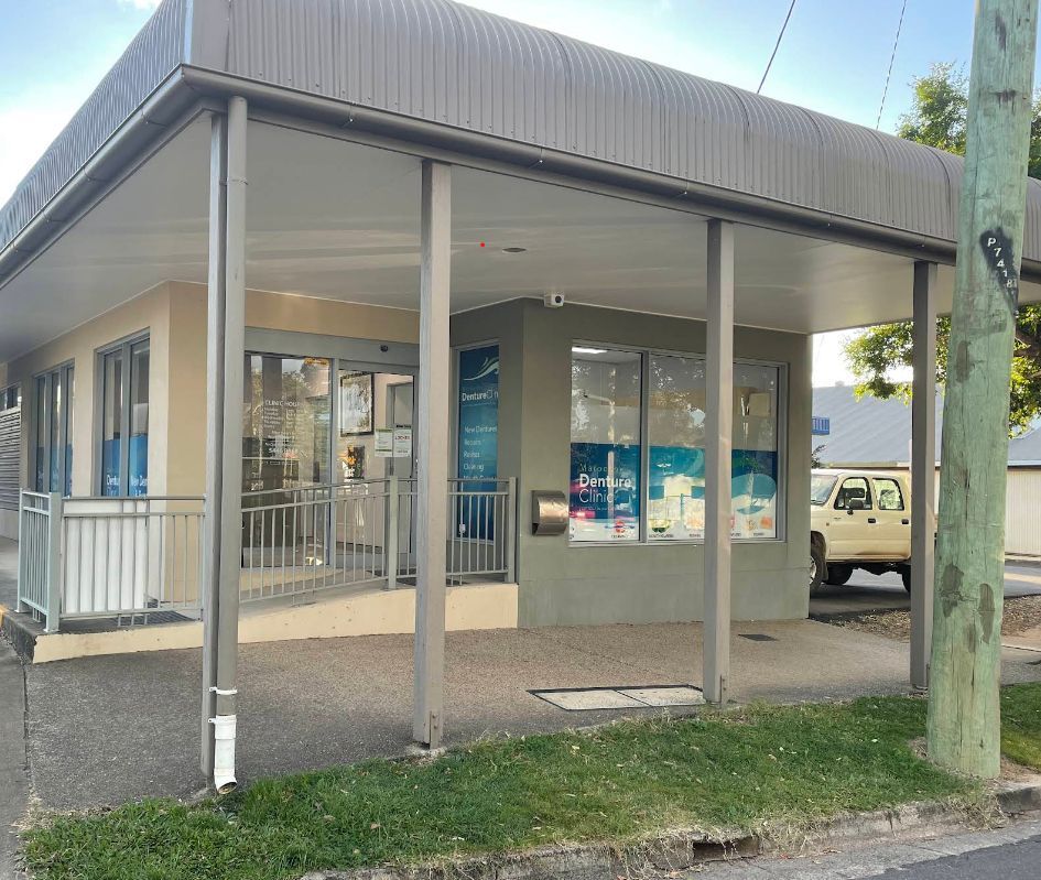 A Building With a Covered Porch and a Truck Parked in Front of It — Maroochy Denture Clinic In Yandina, QLD