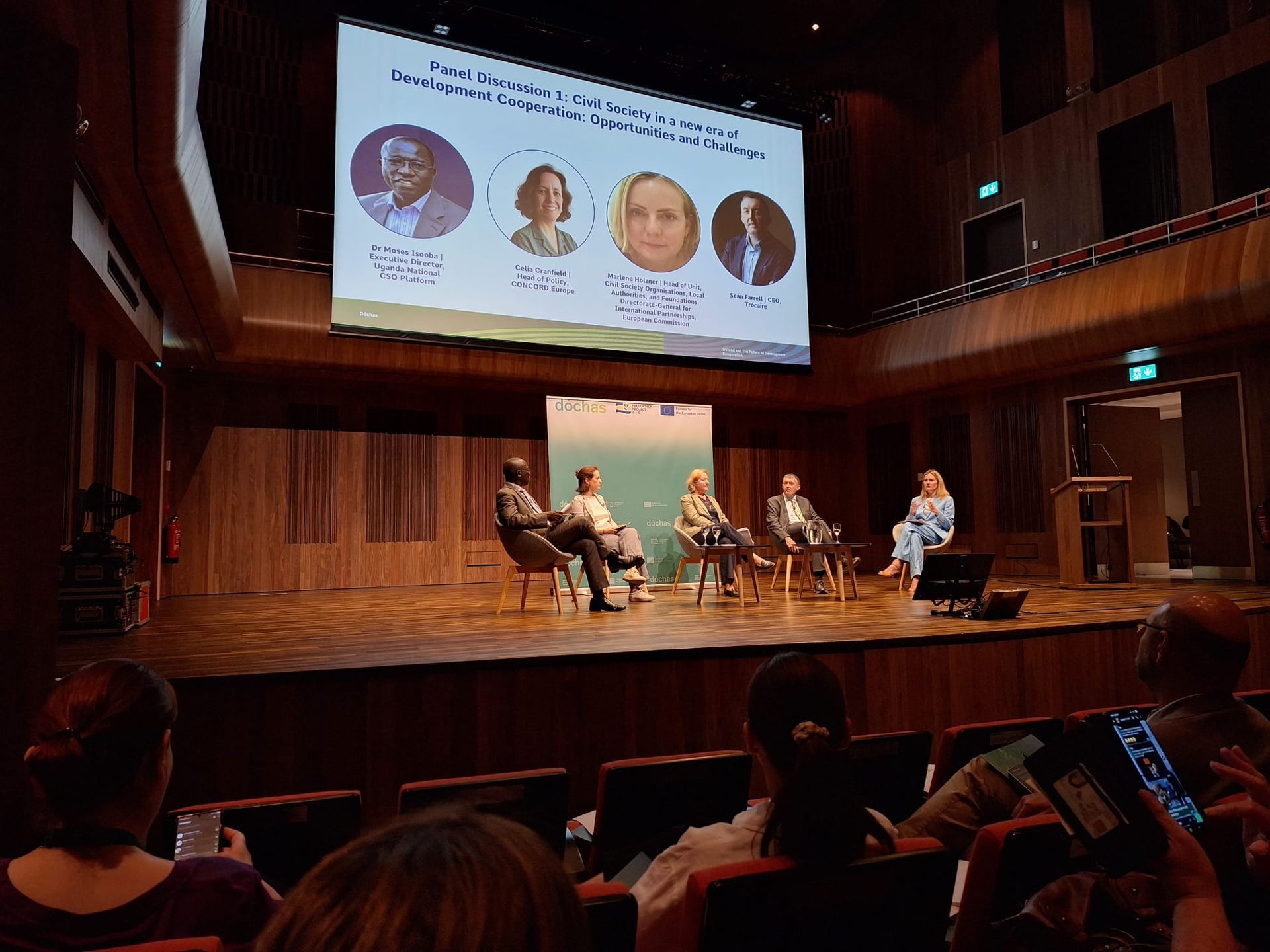 audience pov of a panel discussion on a stage