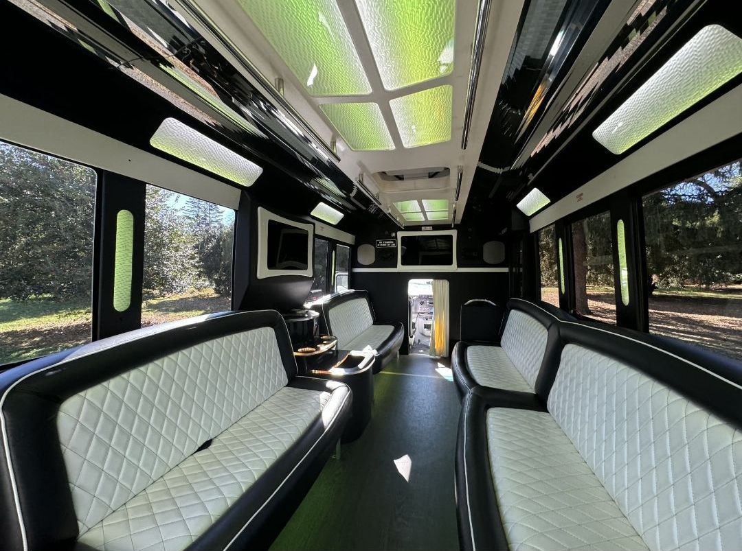 The inside of a limousine with black and white seats.