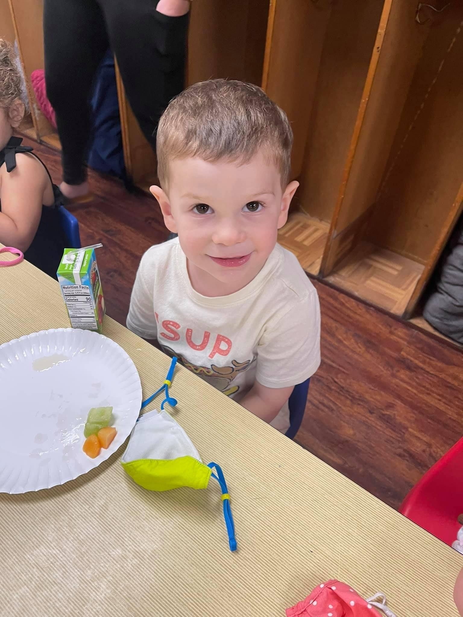 young boy during snack time