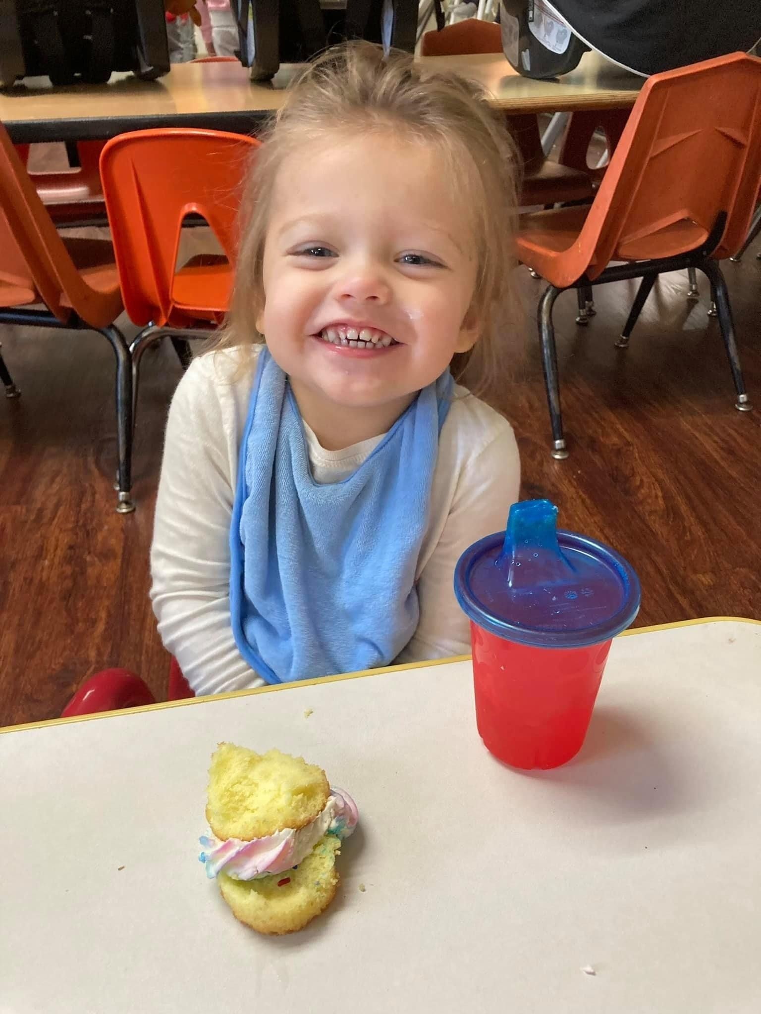 small happy child with a sippy cup