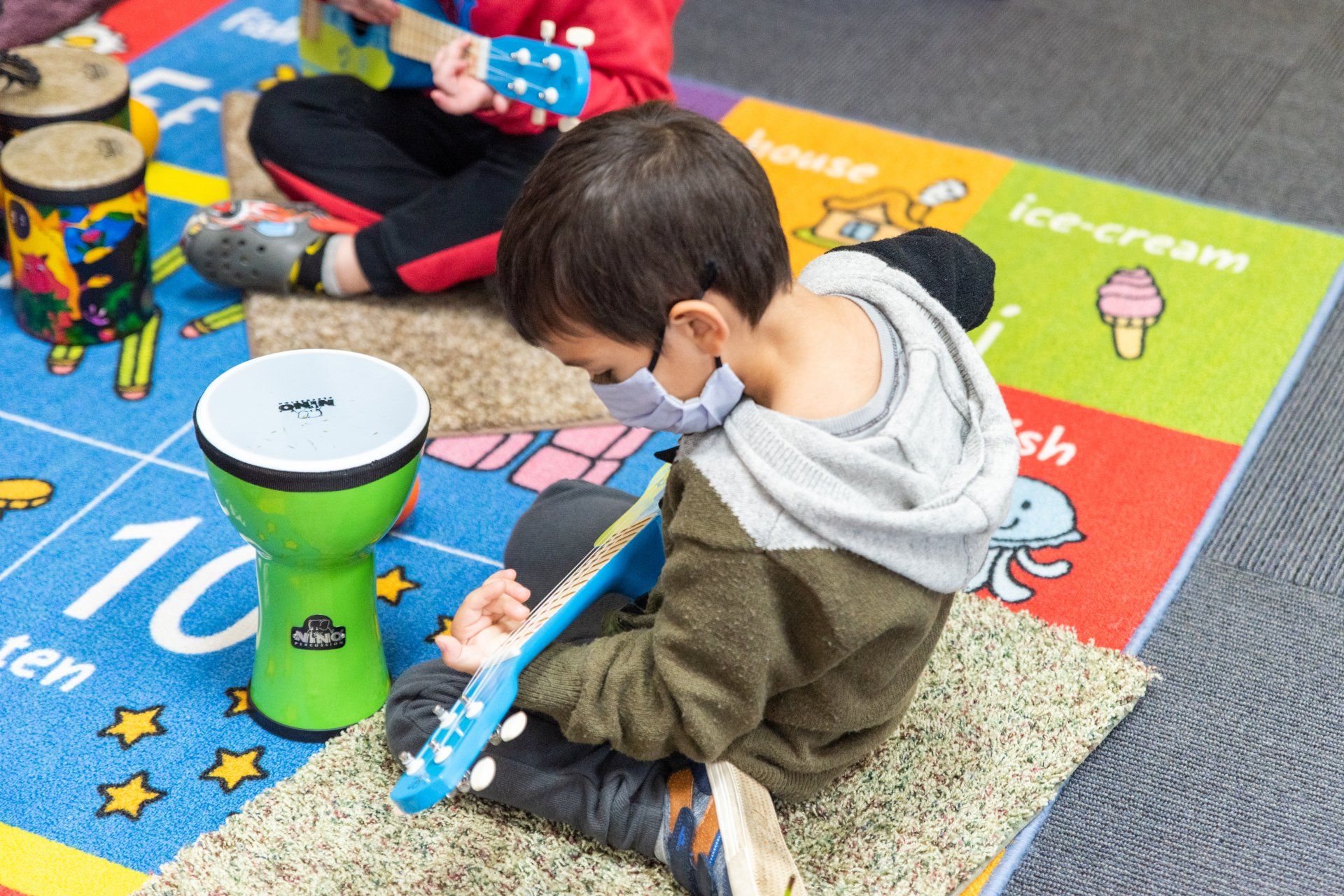 small child playing a guitar