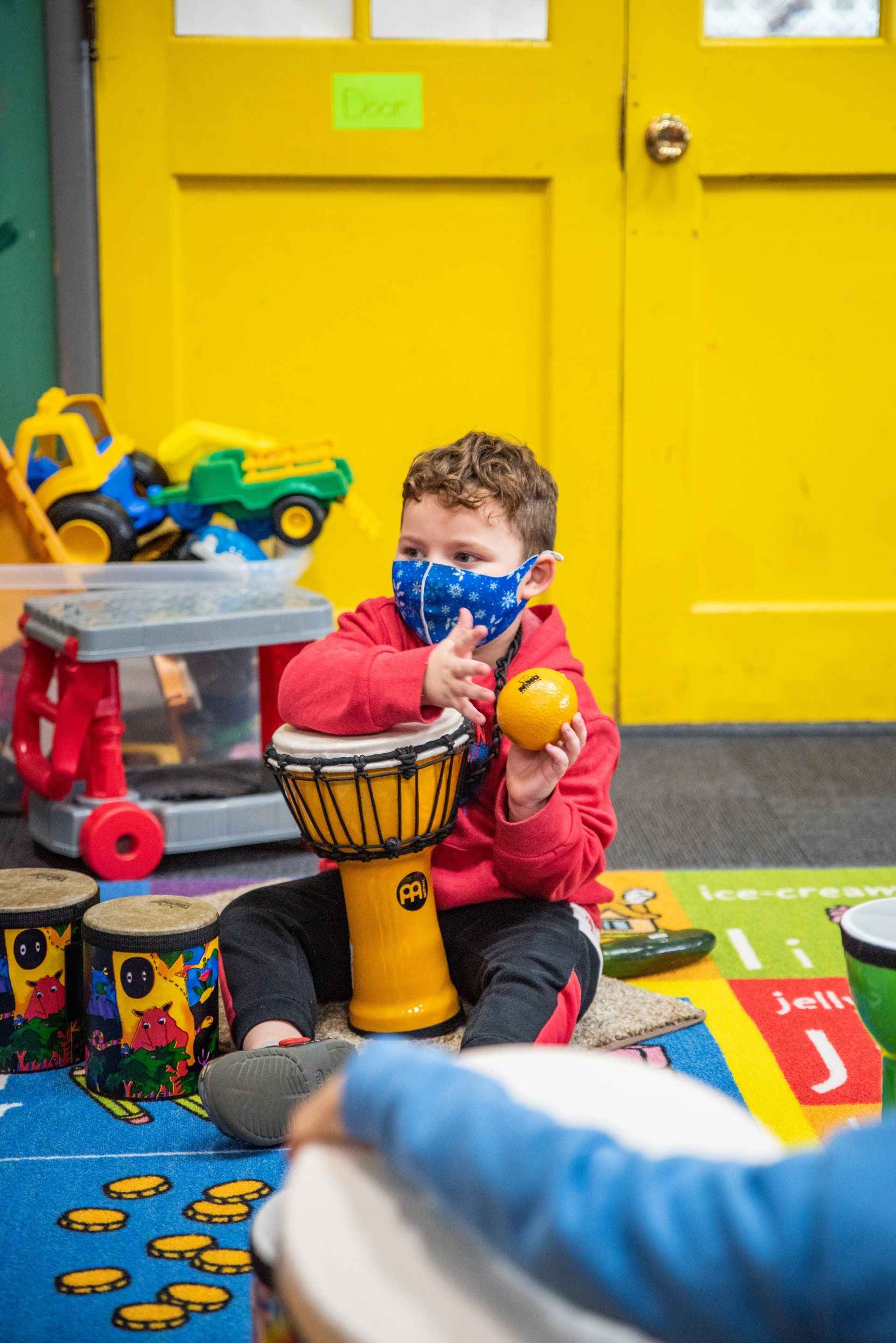 small child playing the bongos