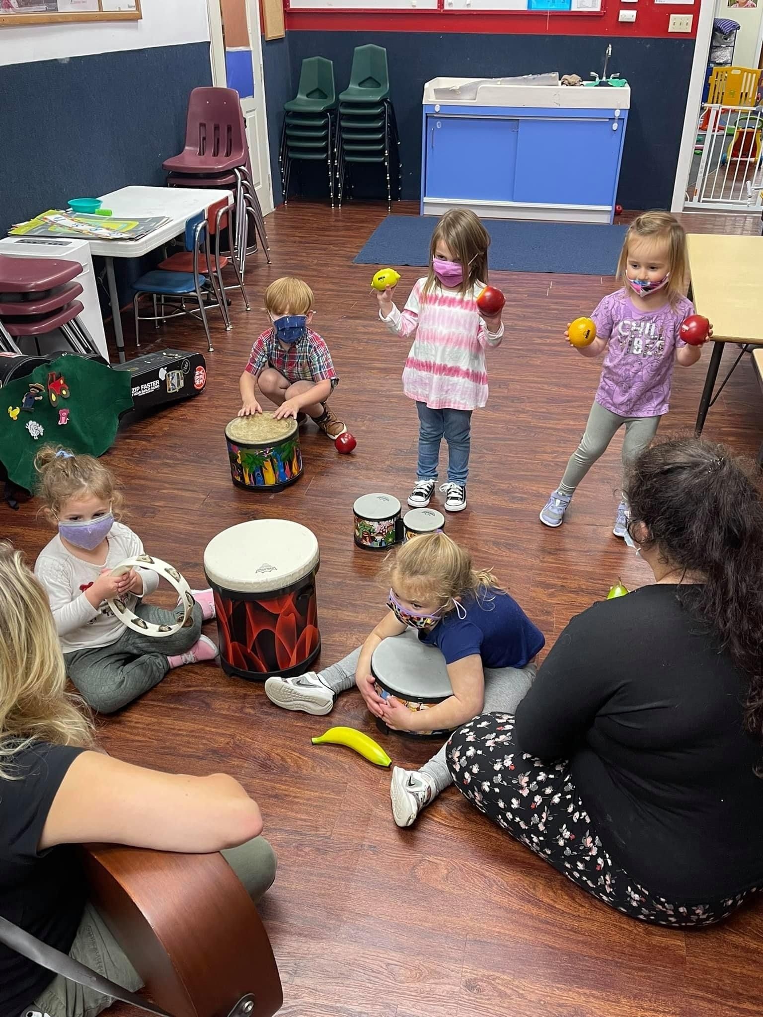 small kids playing the drums