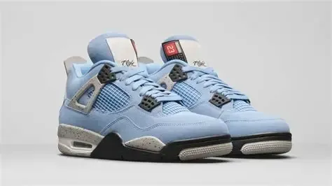 Light blue and gray Air Jordan 4 sneakers with black and white accents.