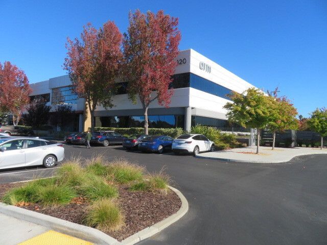 A building with a lot of cars parked in front of it