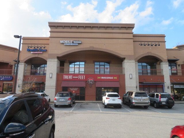 A building with a lot of cars parked in front of it