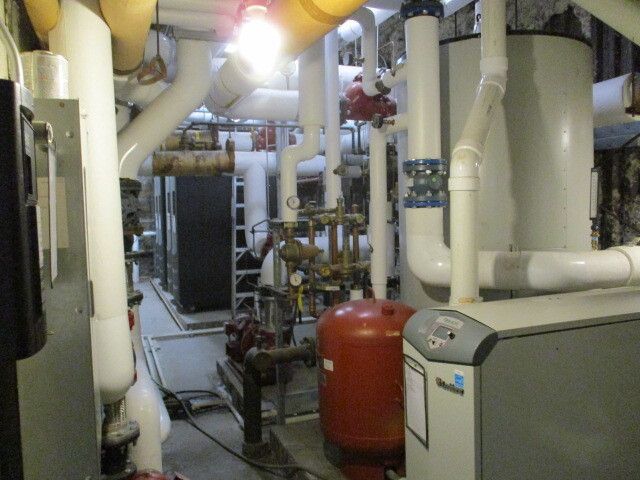 A room filled with lots of pipes and a boiler