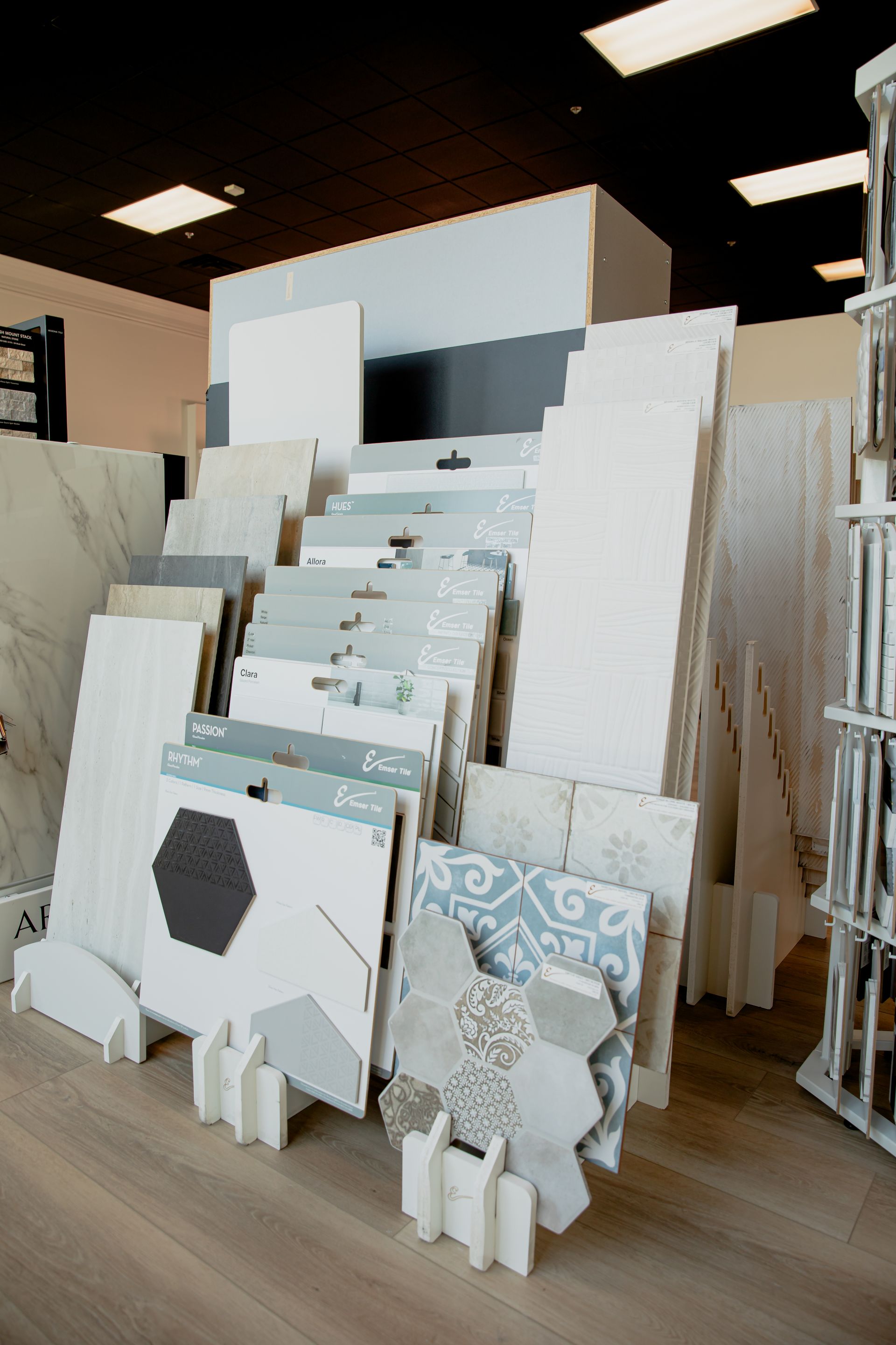 There are many different types of tiles on display in a store.