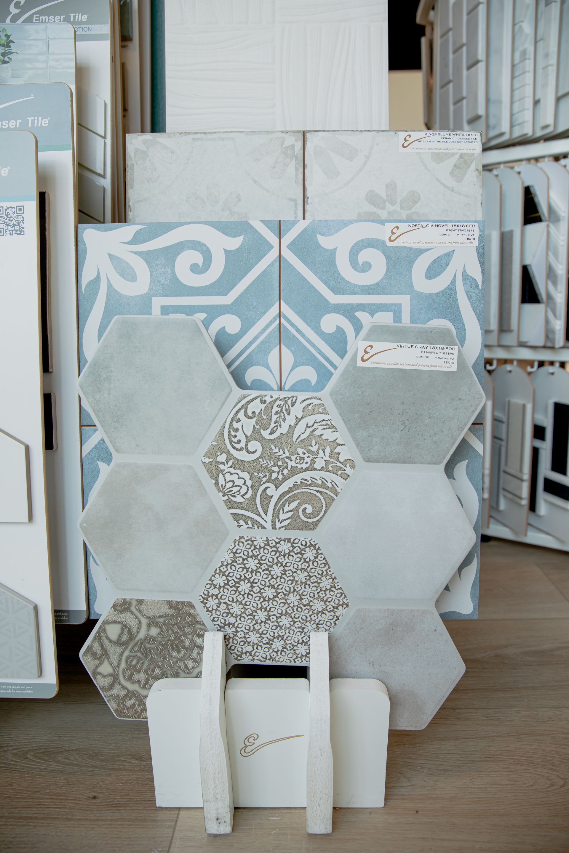 A display of tiles on a wooden floor in a store.