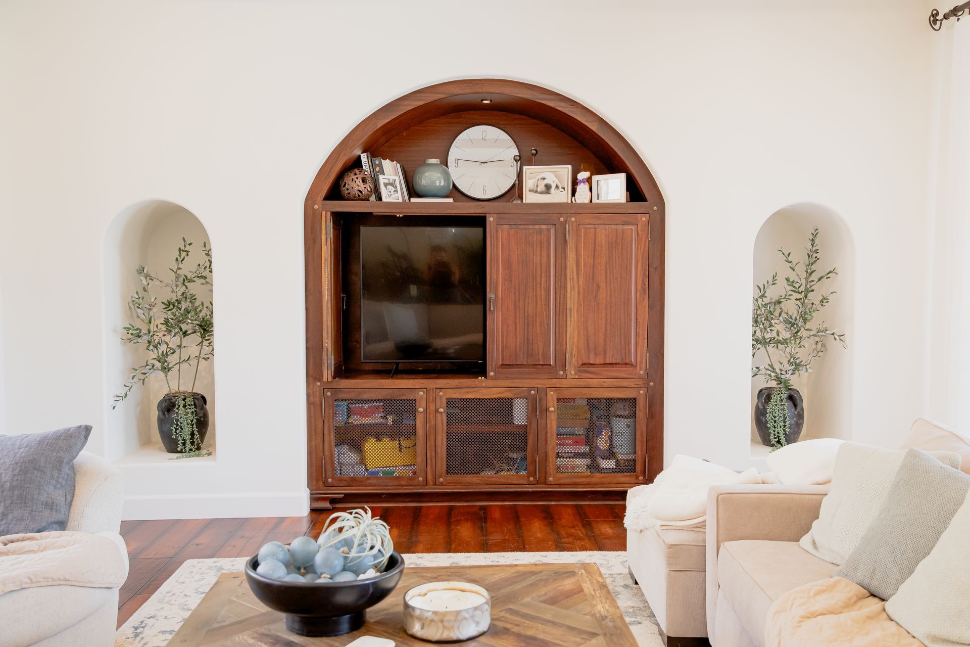 beautiful solid wood, hand-crafted entertainment center in alcove in the wall