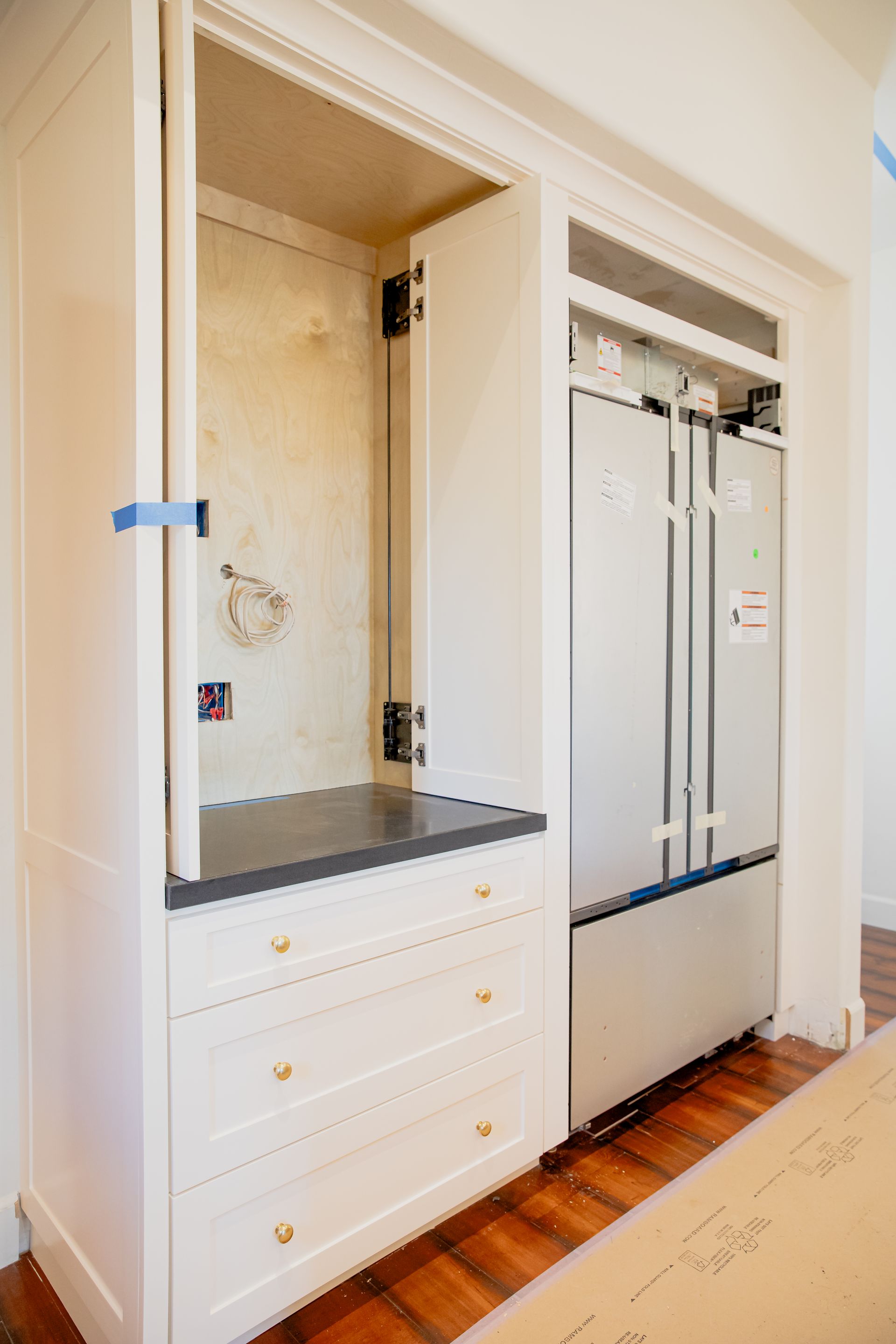 A kitchen with a refrigerator and a sink in it.