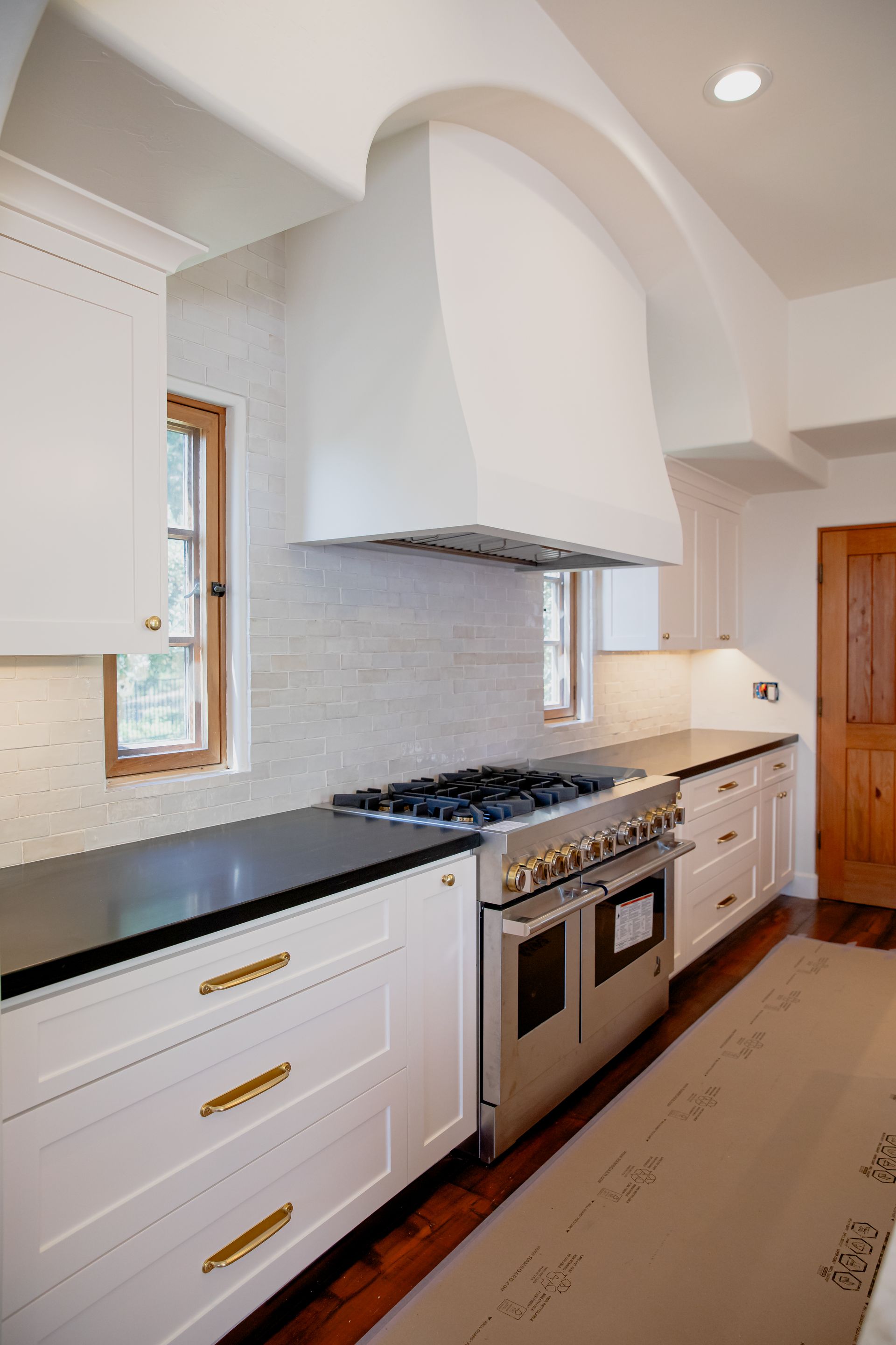 A kitchen with stainless steel appliances and white cabinets