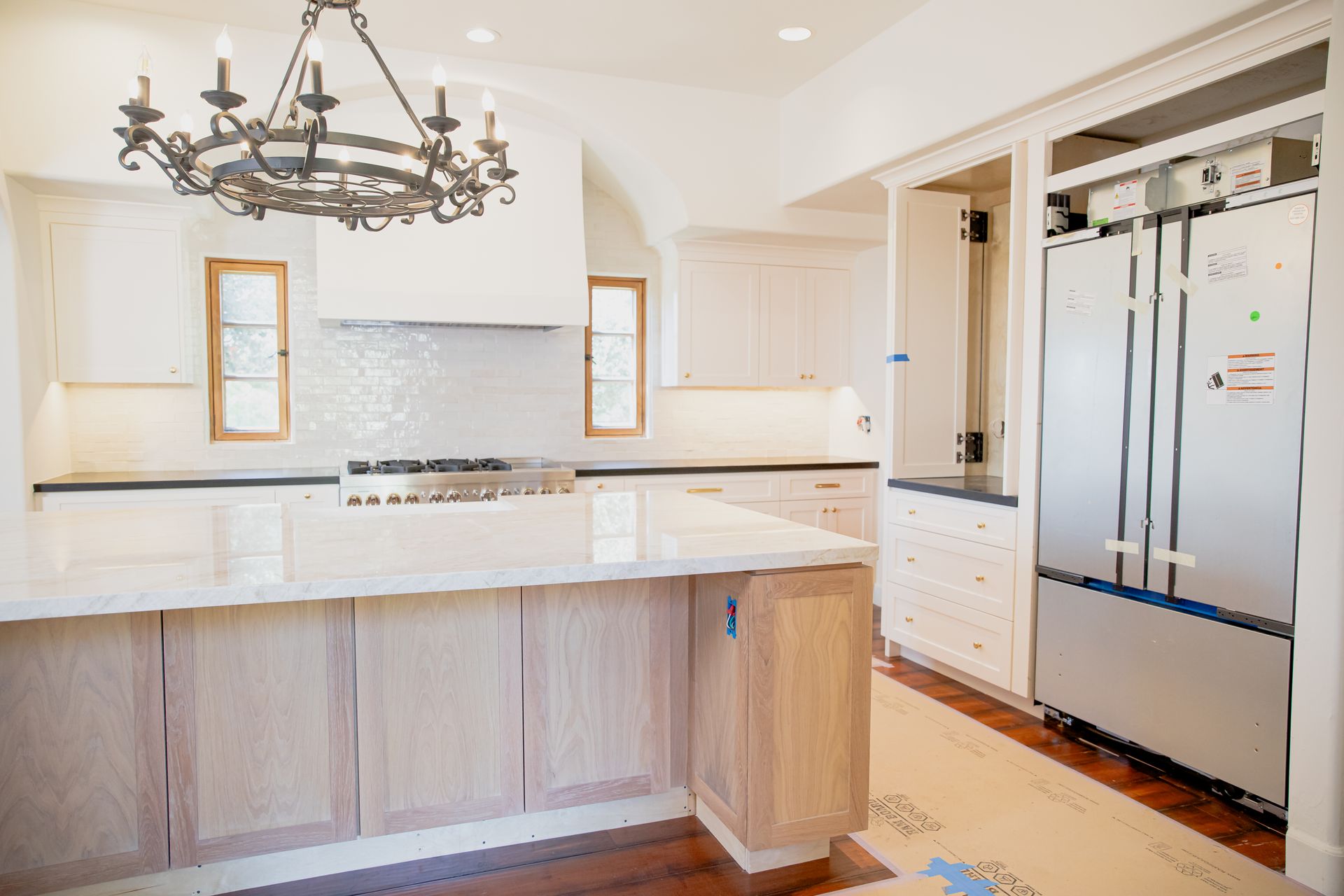 A kitchen with stainless steel appliances and a large island.