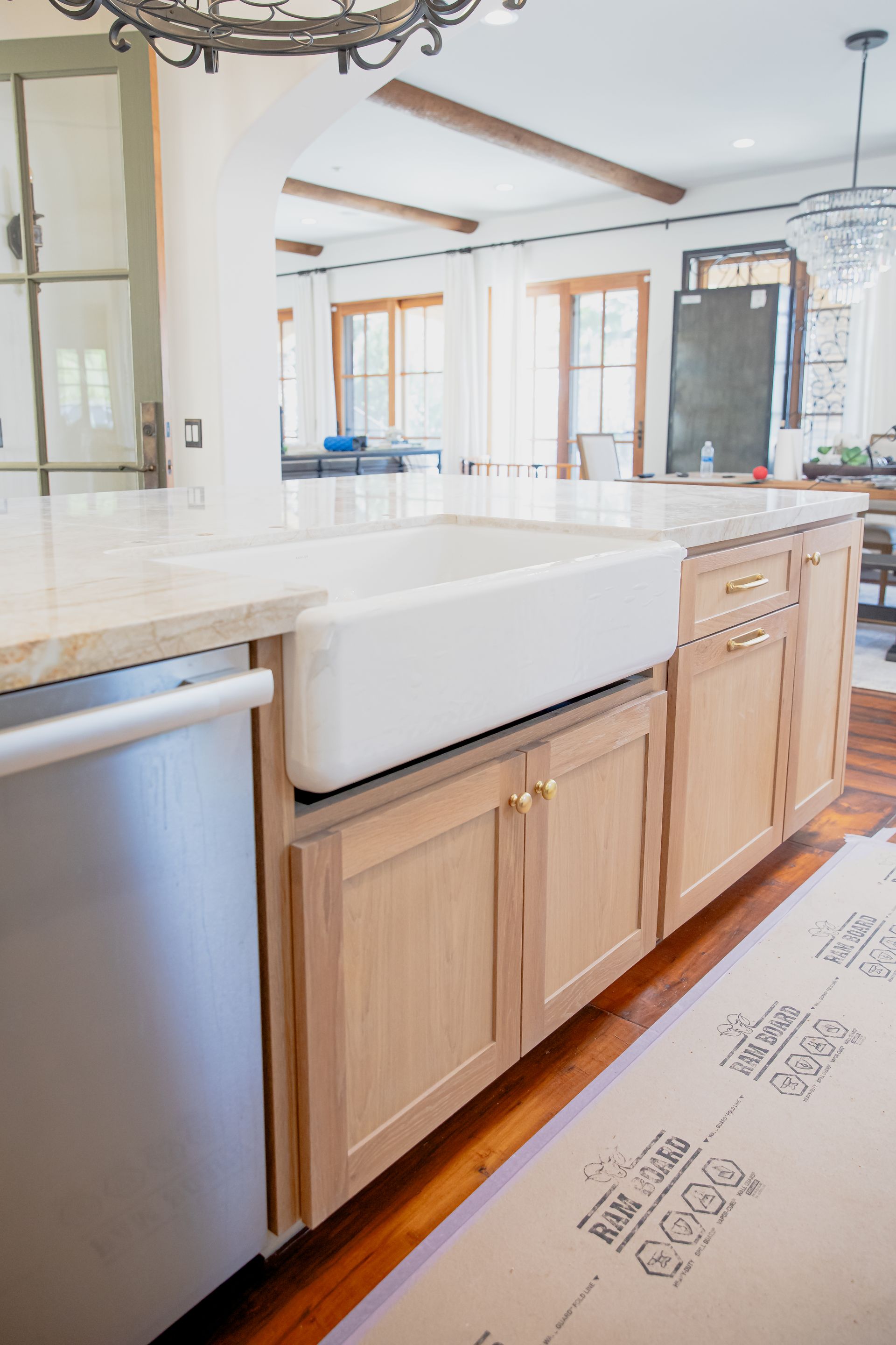 A kitchen with a white sink and stainless steel appliances.