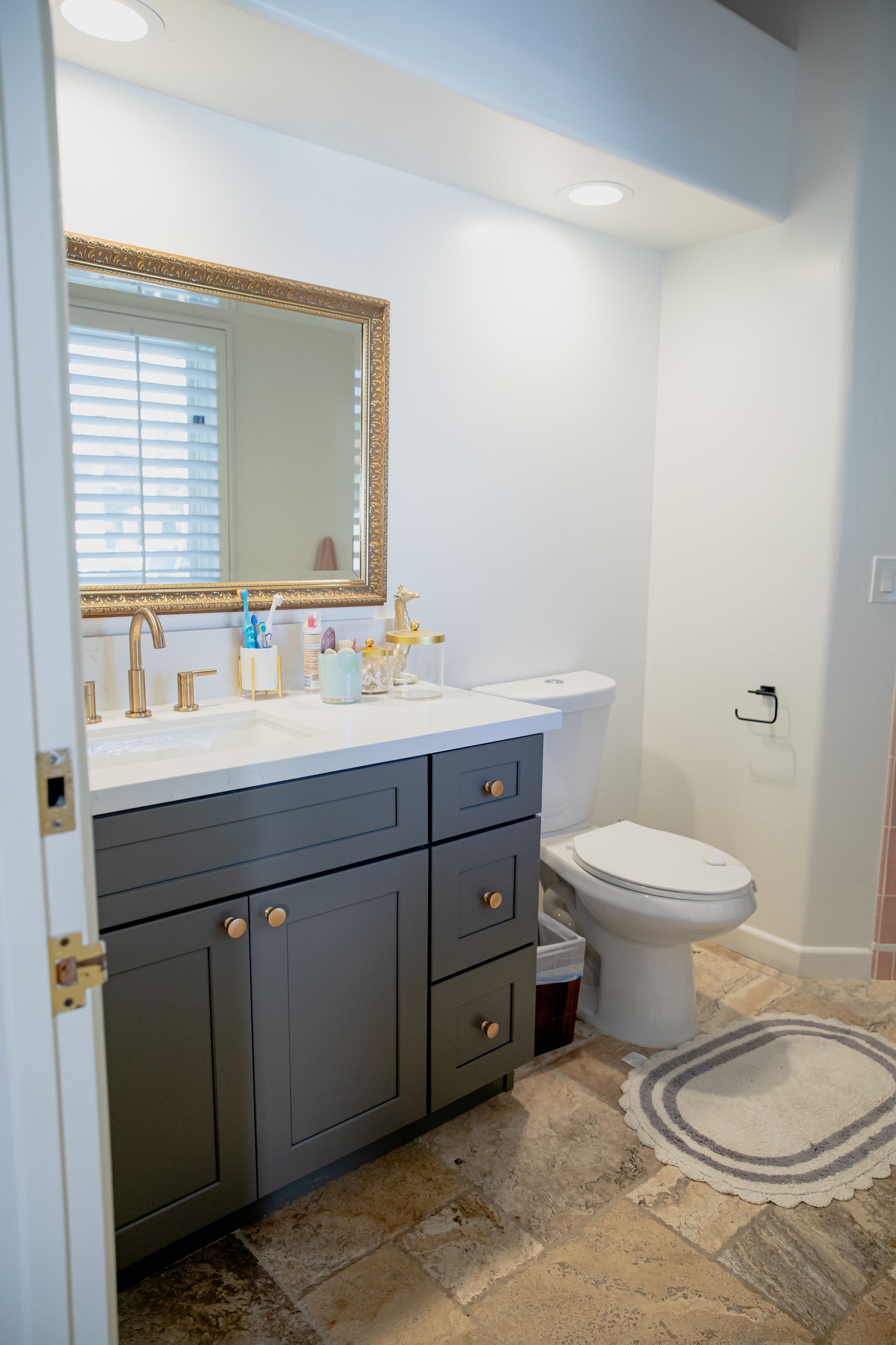 A bathroom with a sink , toilet and mirror.