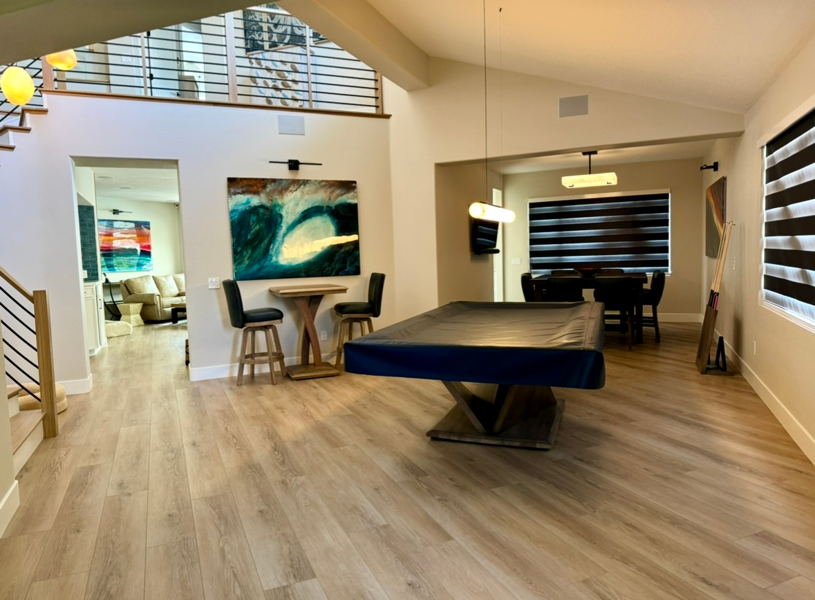 There is a pool table in the middle of the room.