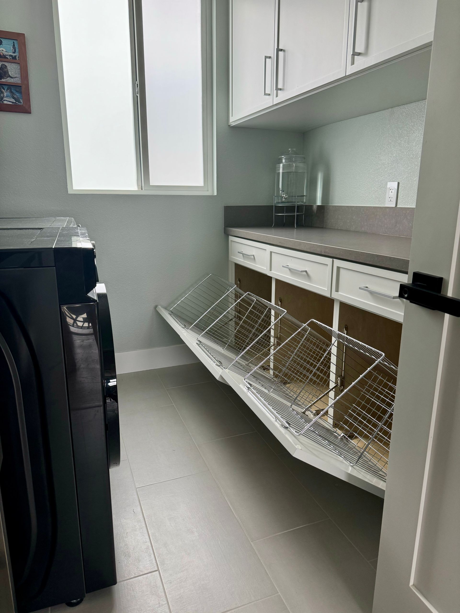 A laundry room with a washer and dryer and a window.
