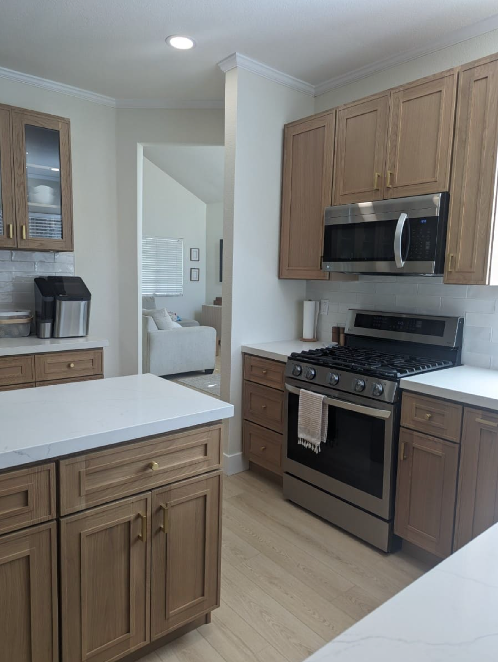 A kitchen with stainless steel appliances and wooden cabinets