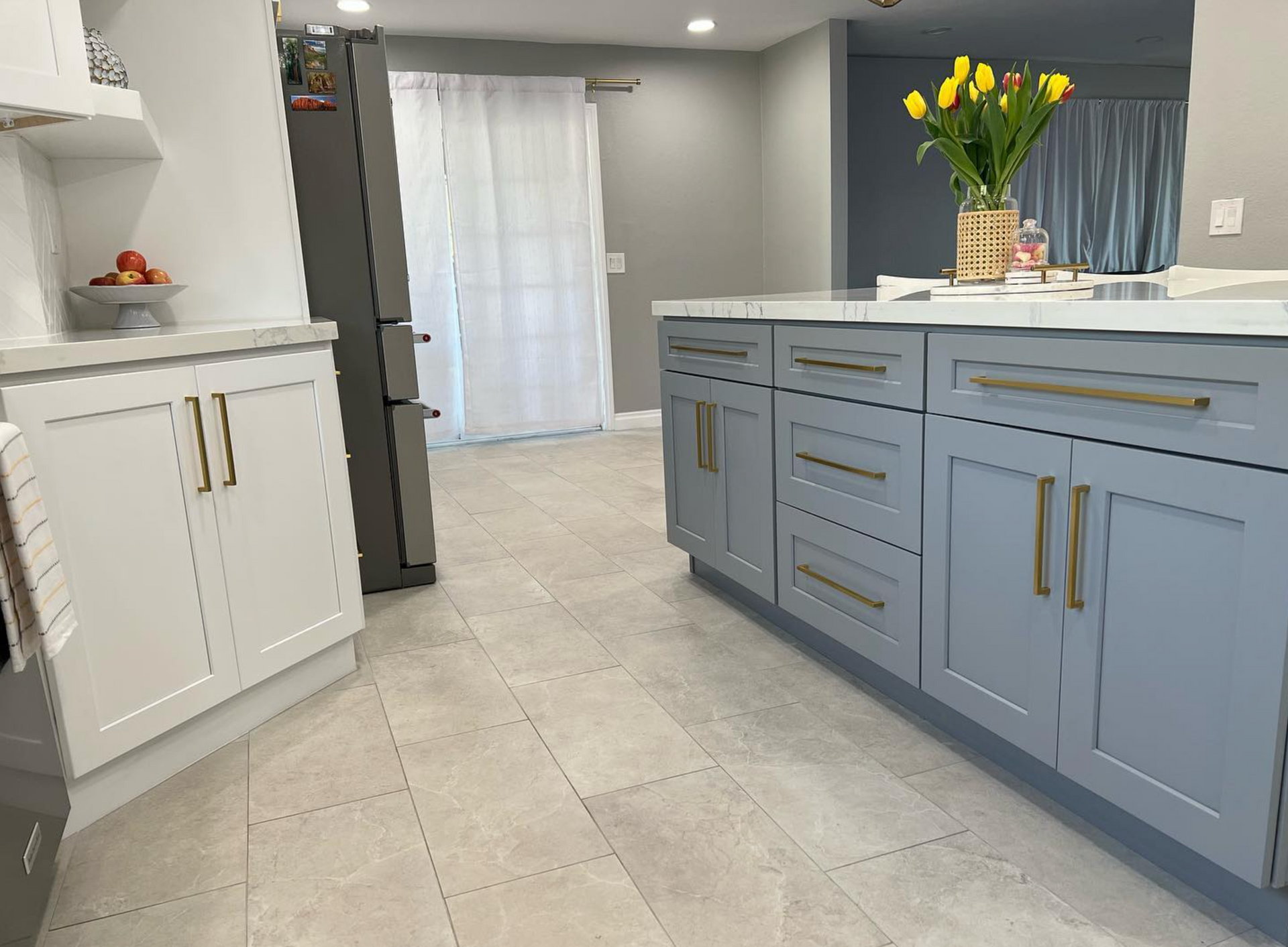 A kitchen with blue cabinets and a large island.