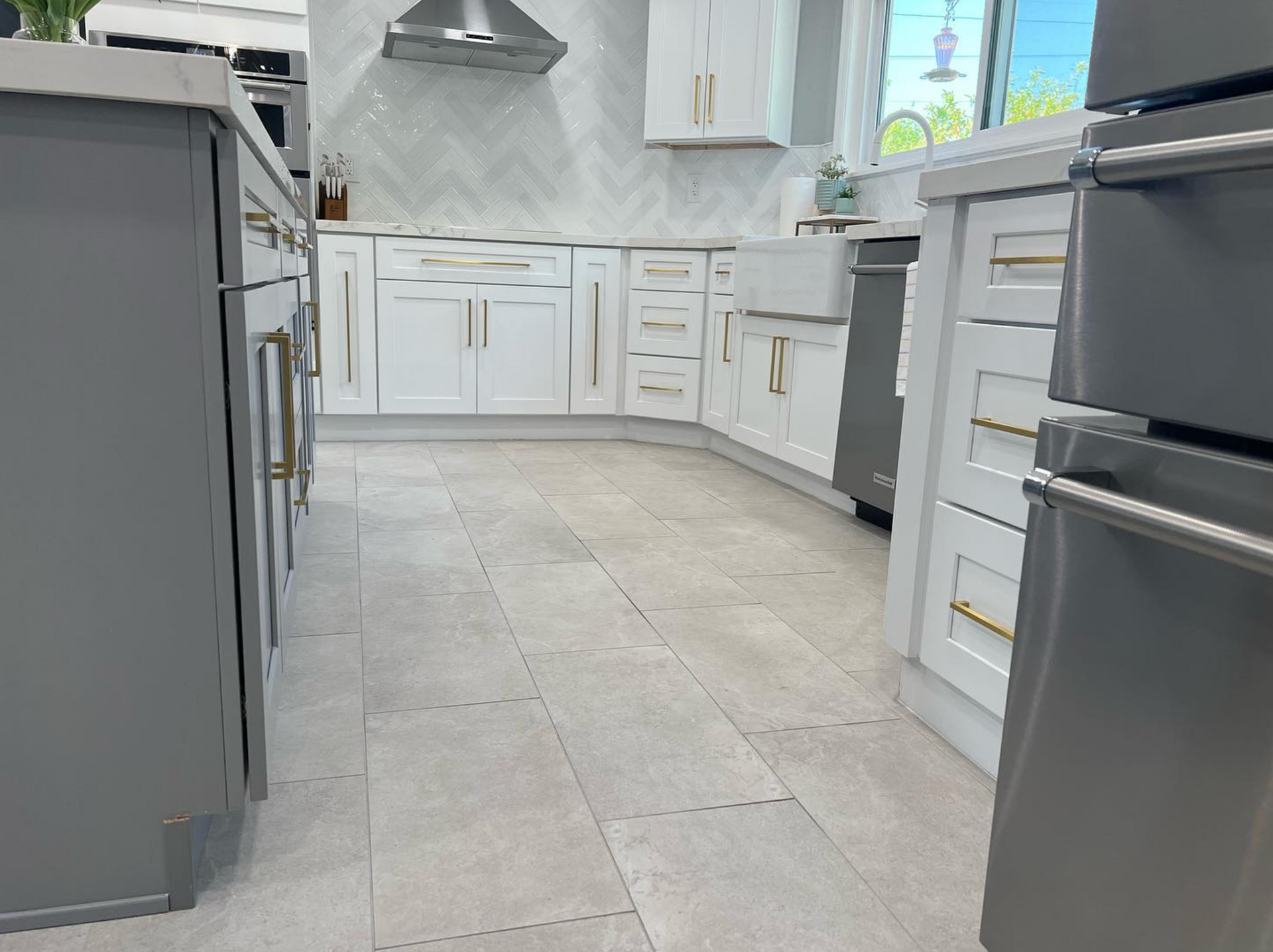 A kitchen with white cabinets and stainless steel appliances.