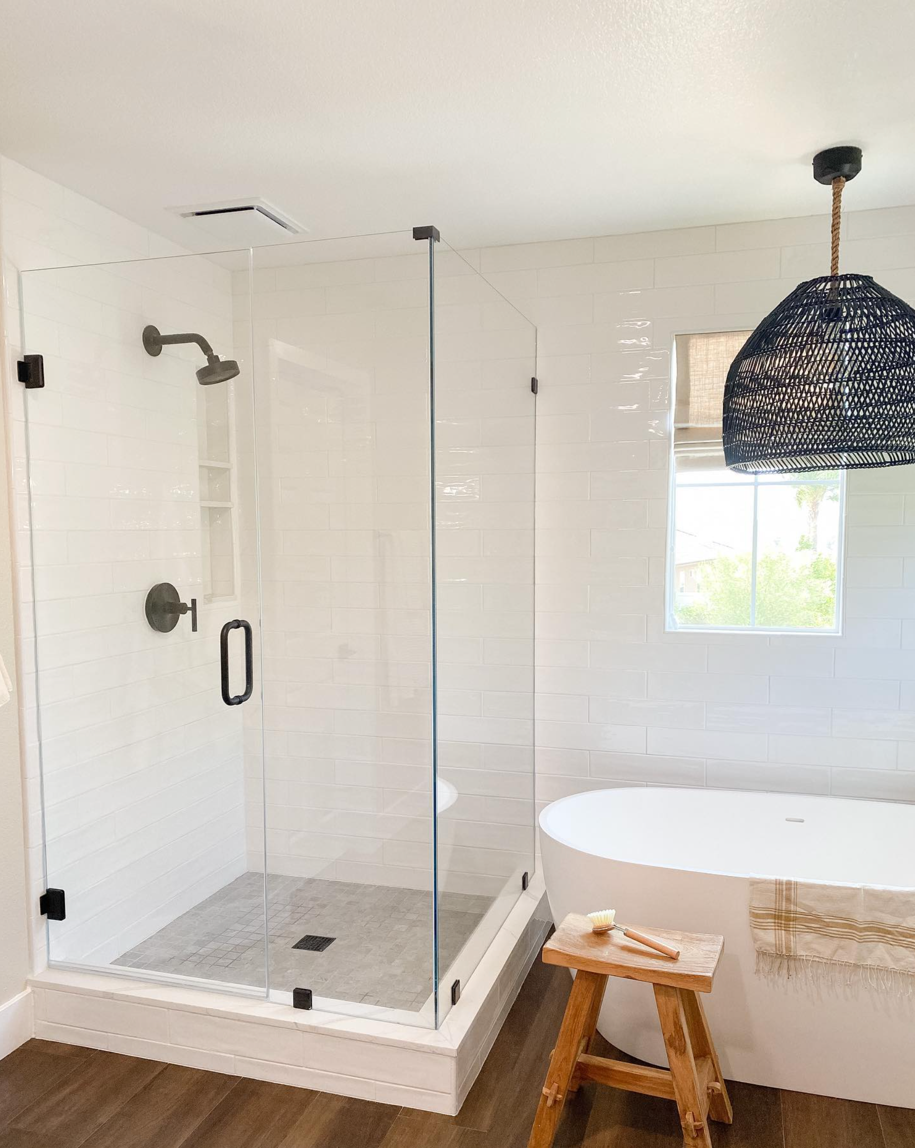 A bathroom with a tub , shower , and glass door.