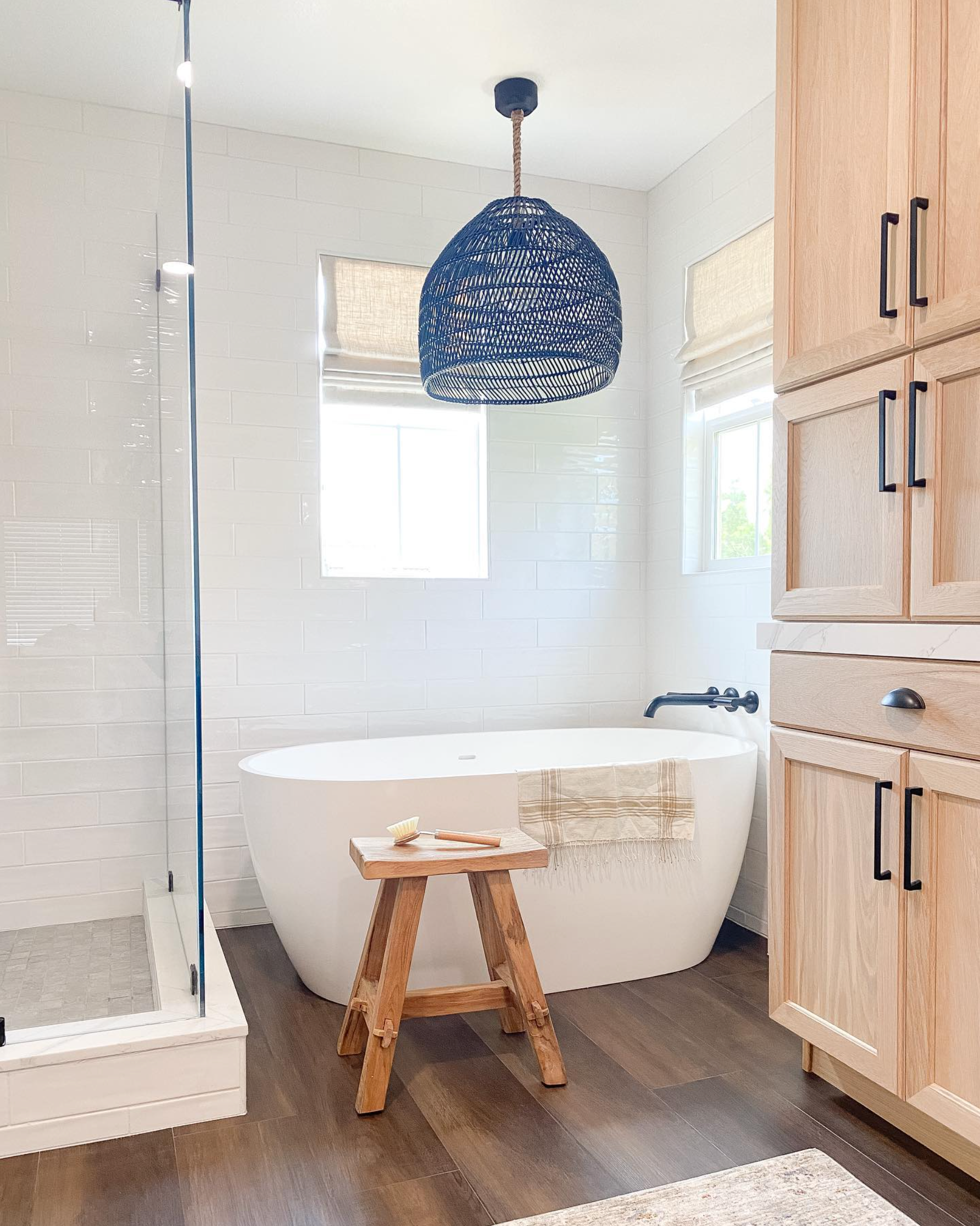 A bathroom with a bathtub and a wooden stool.