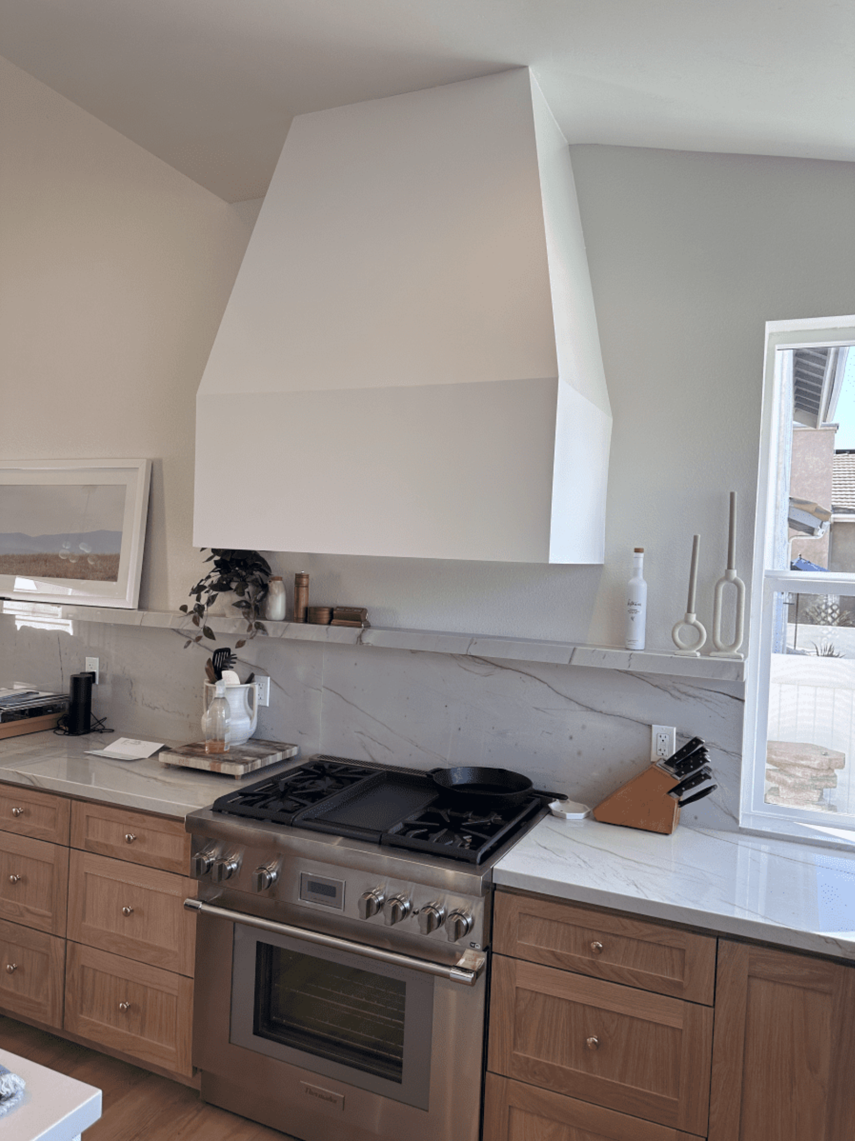 A kitchen with stainless steel appliances and wooden cabinets.