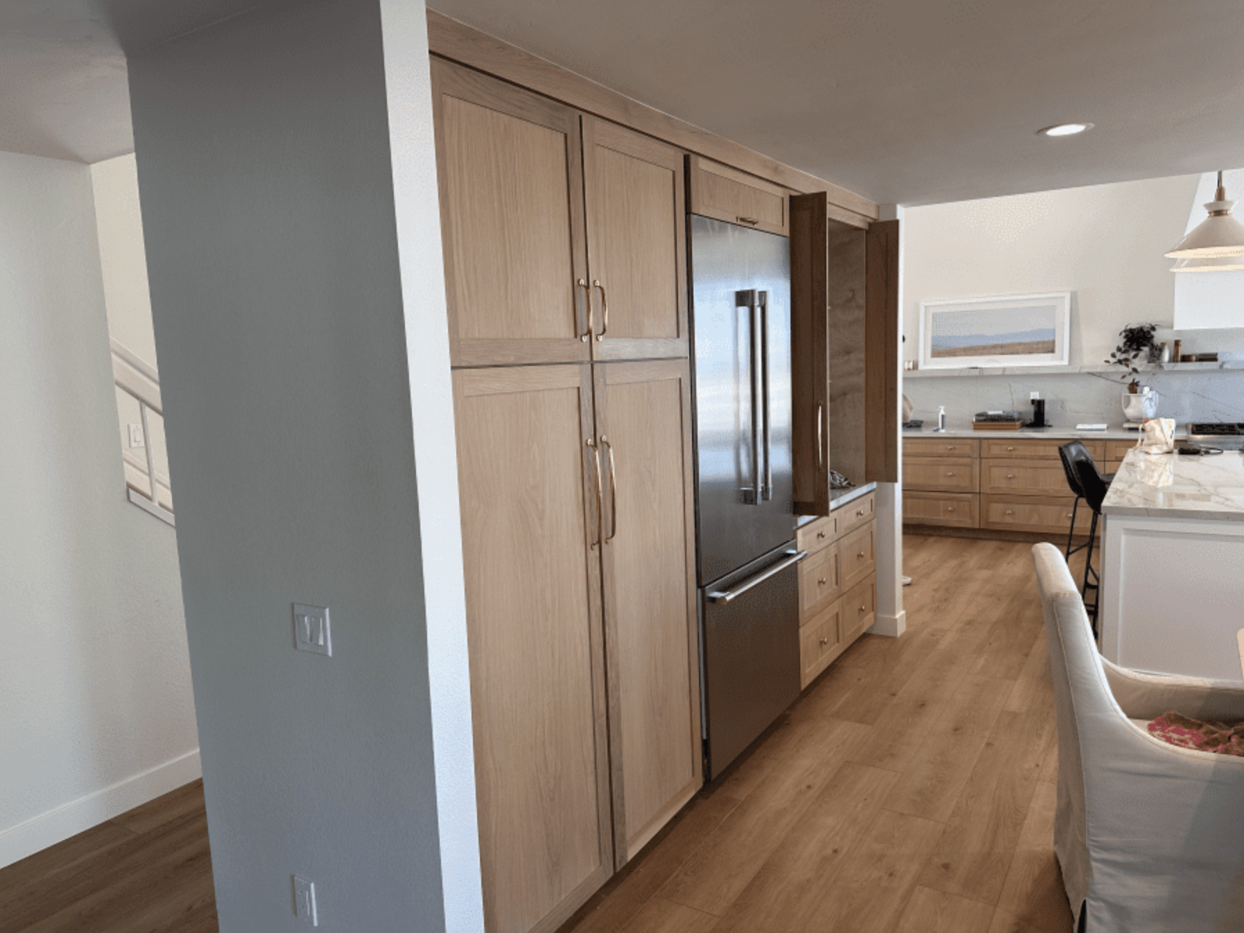 A kitchen with stainless steel appliances and wooden cabinets.