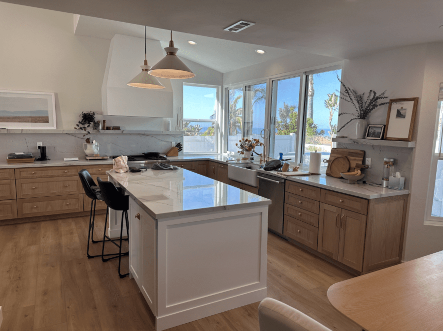 A kitchen with a large island in the middle and lots of windows.